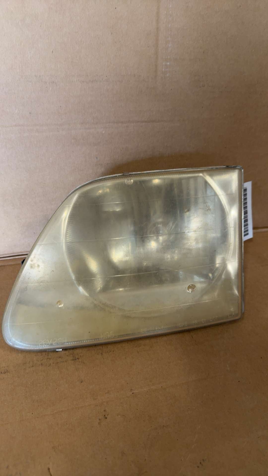 Headlight Assembly from a 2000 Ford Expedition, left side, photo 1