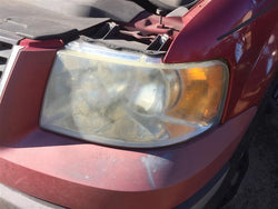 Headlight Assembly from a 2003 Ford Expedition, left side, photo 1