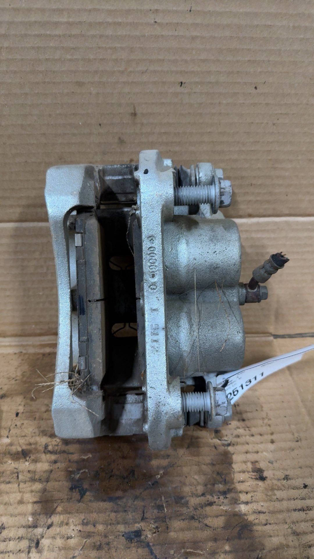 Brake Caliper from a 2020 Nissan Titan, front, left side, photo 2