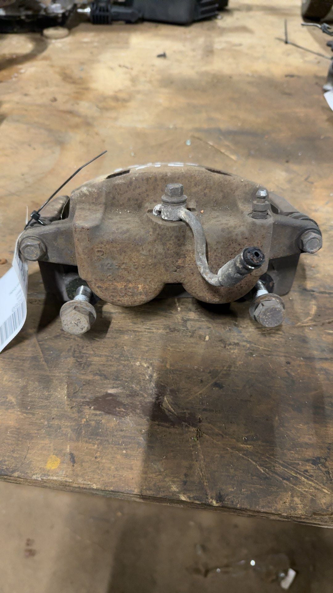 Brake Caliper from a 2006 Nissan, front, left side, photo 1