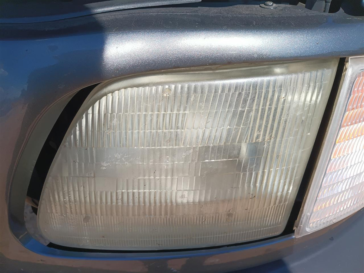 Headlight Assembly from a 2002 Ford F-150, left side, photo 1